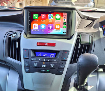 A touchscreen car stereo system installed in a vehicle's dashboard, displaying a colorful interface with icons for Apple CarPlay features.