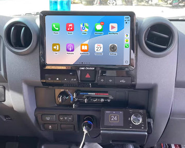 A 10-inch GPS infotainment system installed in a Toyota Land Cruiser vehicle, featuring touchscreen display with Apple CarPlay and Android Auto icons.