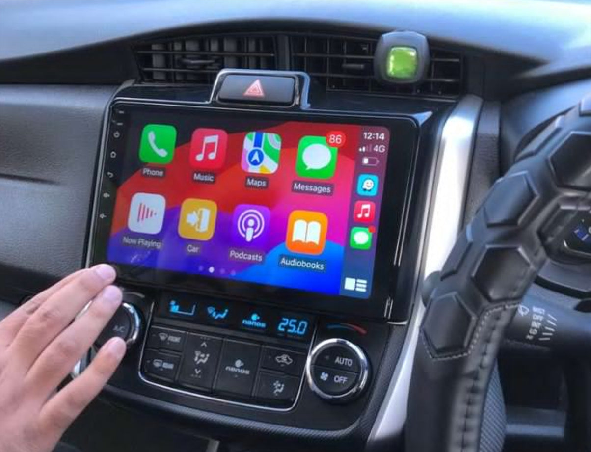 A touchscreen car stereo system displaying Apple CarPlay interface, installed in a vehicle's dashboard.