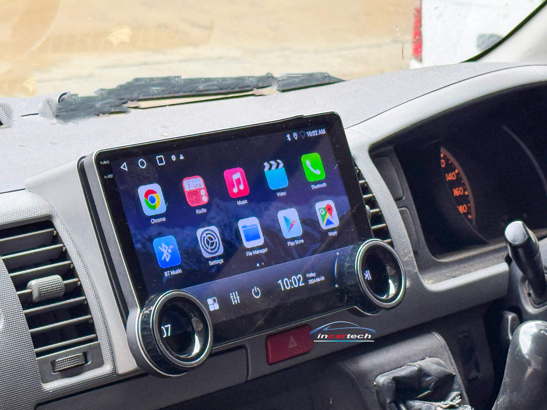 A 10.1-inch motor vehicle A/V player with dual knob control installed in a vehicle's dashboard, featuring a touchscreen interface displaying icons for Apple CarPlay and Android Auto.