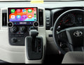 An aftermarket GPS wireless stereo radio interface installed in a Toyota Hiace vehicle, featuring a touchscreen display, dual knob control, and integration with the vehicle's steering wheel and dashboard.