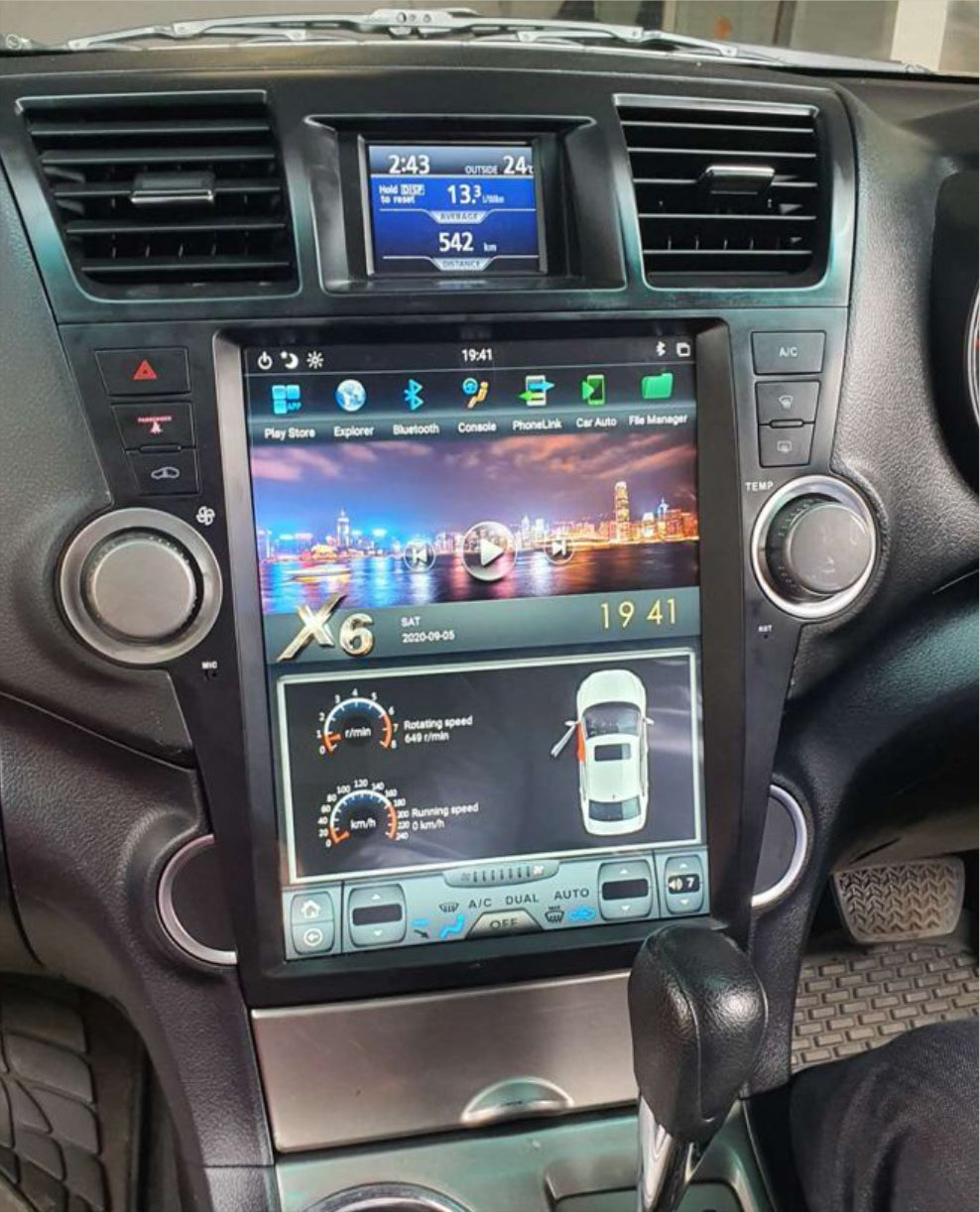 A 12.1-inch touchscreen car stereo radio interface with a steering wheel control interface, marked with a touchscreen displaying various app icons, and two large knobs on the sides.