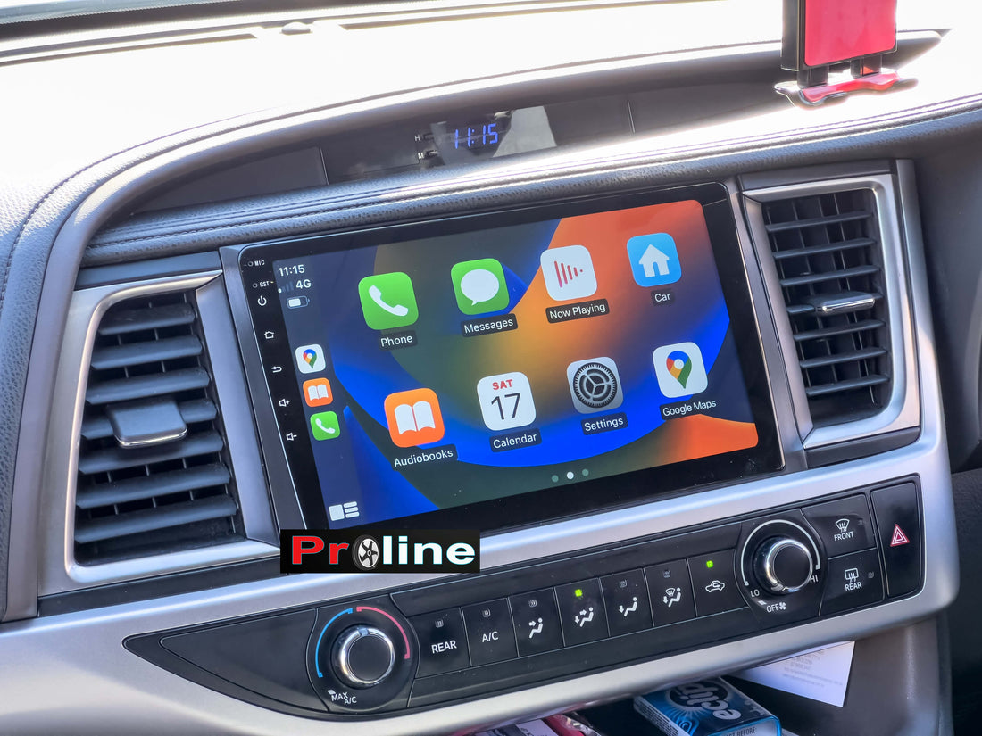 An aftermarket touchscreen car multimedia system installed in a vehicle, displaying a colorful interface with icons for Apple CarPlay and Android Auto features.