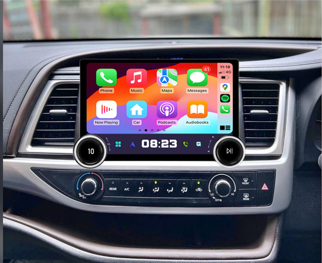 A 10 touchscreen car audio and vehicle information system installed in a vehicle's dashboard, displaying a colorful interface with icons for Apple CarPlay and Android Auto features.