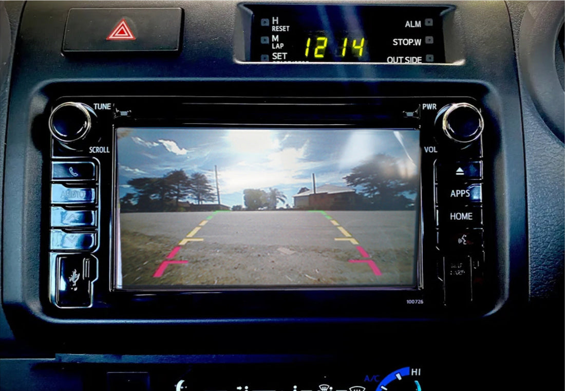 A Toyota Land Cruiser vehicle's interior showing the rear view camera display on the touchscreen monitor.