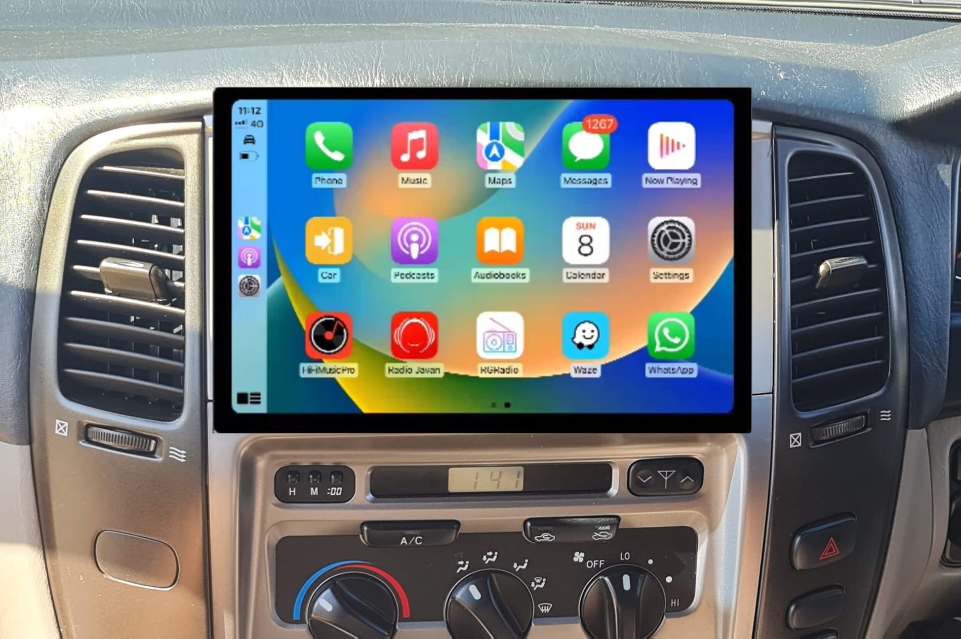 A 13.3-inch touchscreen car stereo installation in a vehicle's dashboard, displaying a colorful interface with icons for Apple CarPlay and Android Auto features.