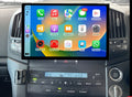 An aftermarket touch screen car stereo system interface displayed inside a vehicle's dashboard. The screen shows icons for Apple CarPlay and Android Auto features.