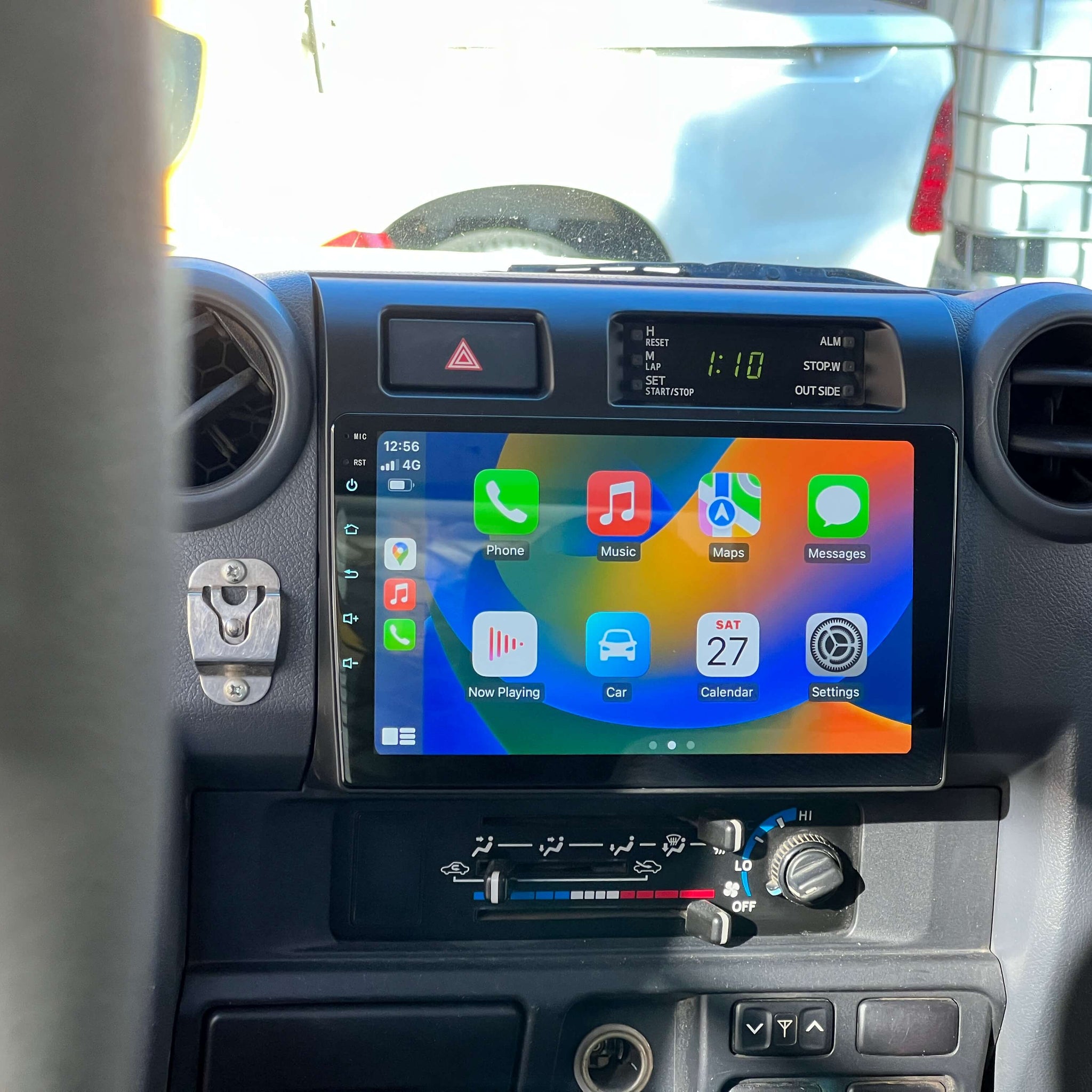 An in-dash car audio and visual system with a touchscreen display, installed in a vehicle's dashboard.