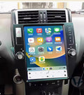 A 12.1-inch vertical screen car stereo installed in a vehicle's dashboard, featuring icons for Apple CarPlay and Android Auto functions.